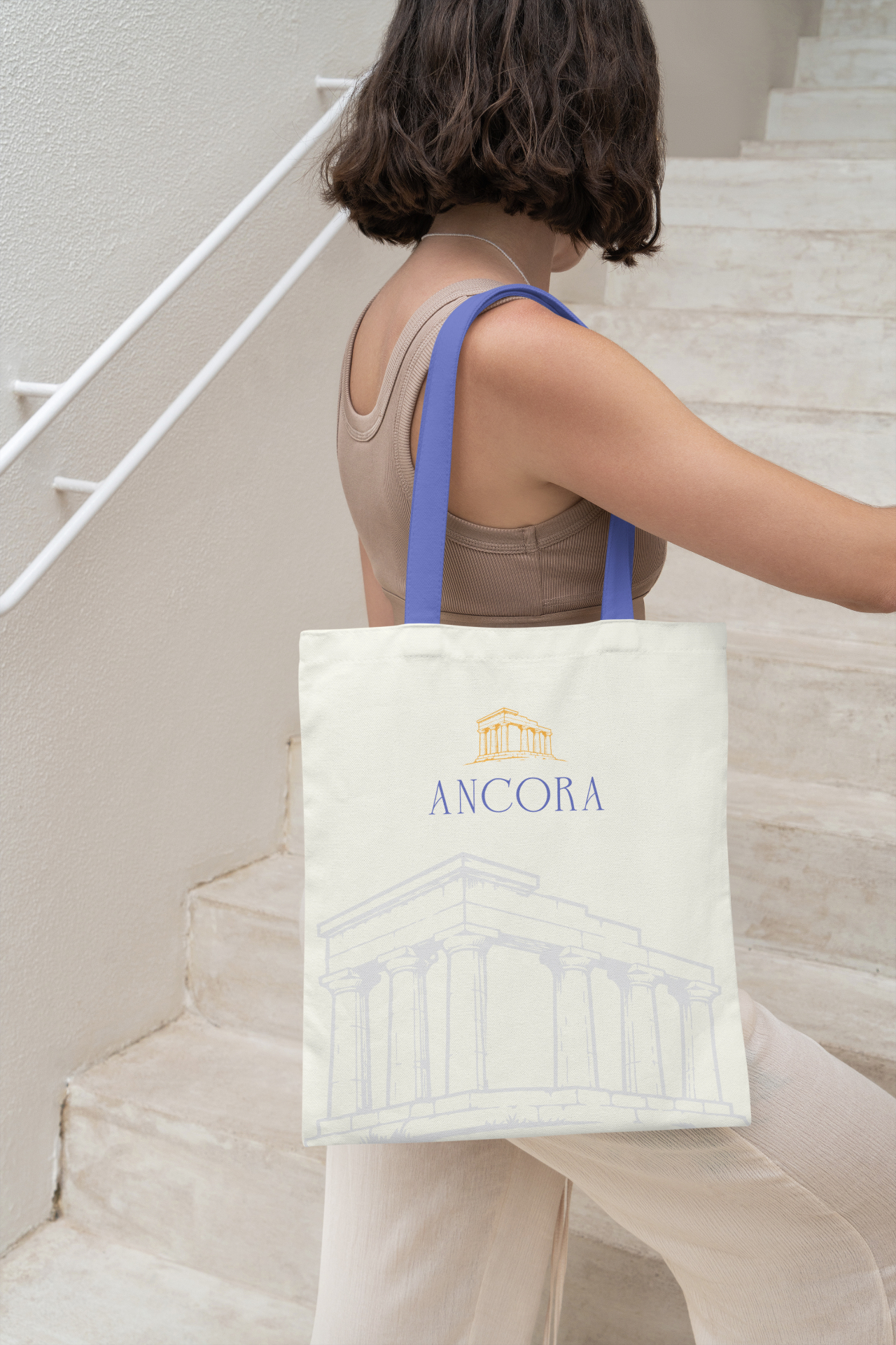 Student carrying an Ancora tote bag on stone steps in Salemi